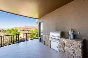 Patio / terrace with exterior kitchen and a mountain view