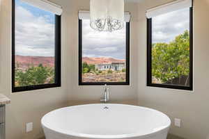 Full bathroom featuring a freestanding tub, a mountain view, and vanity