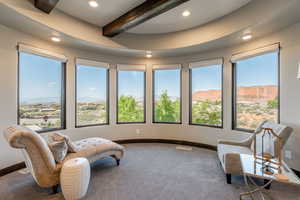 Living area featuring a mountain view, beamed ceiling, recessed lighting, and carpet flooring