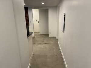 Corridor featuring recessed lighting and concrete floors