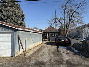 View of home's exterior featuring a chimney and an outdoor structure