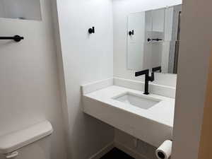 Half bath with toilet and a sink