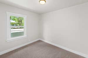 Unfurnished room featuring baseboards and carpet