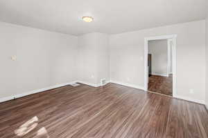 Spare room with wood finished floors and baseboards