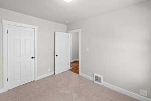 Unfurnished bedroom featuring carpet floors and baseboards