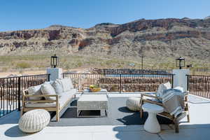 View of patio with an outdoor living space and a mountain view