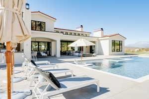 Outdoor pool with outdoor lounge area and a patio