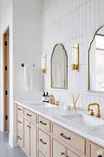 Full bath with double vanity, tasteful backsplash, tile walls, and tile patterned flooring