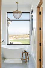 Full bathroom with a soaking tub, plenty of natural light, and tile patterned floors