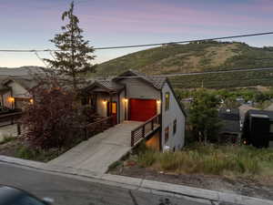 View of front of house featuring concrete driveway, a garage, and a mountain view