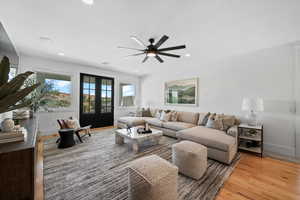 Living area with light wood-type flooring, ceiling fan, french doors, and recessed lighting
