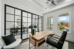Office with recessed lighting and a tray ceiling