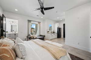 Bedroom with recessed lighting, black fridge with ice dispenser, and ceiling fan