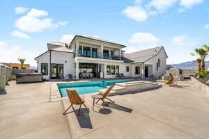 View of swimming pool featuring a hot tub, a patio area, and outdoor lounge area