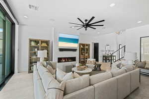 Living room with recessed lighting, a fireplace, stairs, plenty of natural light, and a ceiling fan