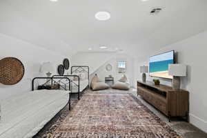 Bedroom featuring vaulted ceiling and recessed lighting