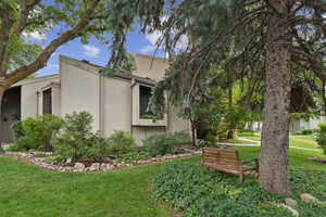 View of side of home with a yard and stucco siding