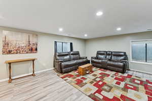 Living area featuring wood finished floors and recessed lighting
