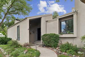Property entrance featuring stucco siding