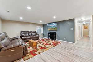 Living room featuring wood finished floors and recessed lighting