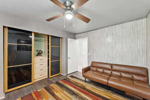 Living room with wood finished floors and a ceiling fan
