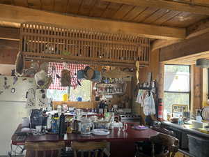 Interior space with a wood ceiling with exposed beams and wood walls