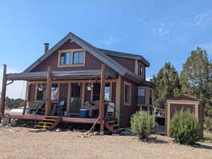Rear view of property featuring covered porch