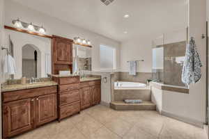 Bathroom with a garden tub, vanity, tile patterned flooring, a tile shower, and recessed lighting