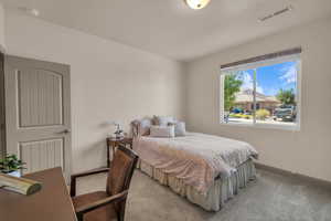 Bedroom with light carpet and baseboards