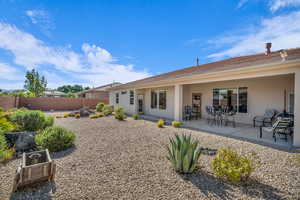 Back of house with stucco siding and a patio area
