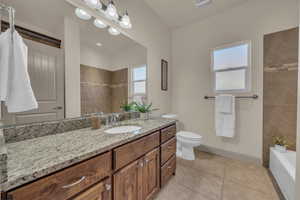 Full bathroom featuring vanity, tile patterned floors, a bath, and tiled shower