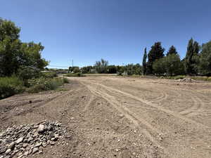View of dirt / gravel road with a rural view