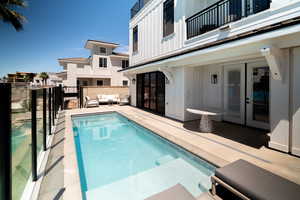 View of pool with french doors, an outdoor living space, and a patio