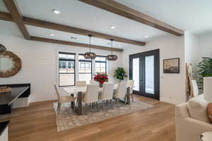 Dining space featuring recessed lighting, light wood finished floors, beam ceiling, and a chandelier