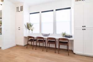 Dining space with light wood-style flooring and a desk