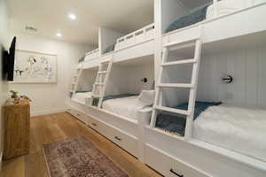Bedroom with wood finished floors and recessed lighting