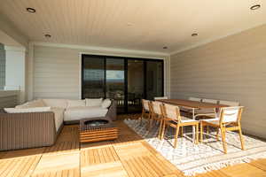 Living room featuring wooden ceiling, wood walls, and wood finished floors