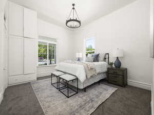 Bedroom with a chandelier and carpet floors