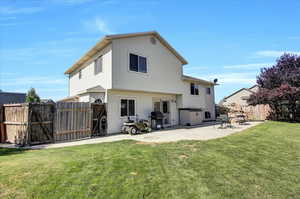 Rear view of property featuring a gate and a patio