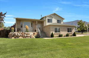 Split level home featuring brick siding
