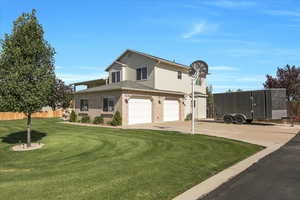 View of front of property featuring a garage, concrete driveway, and brick siding