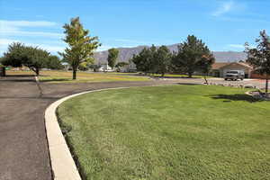 View of community featuring a lawn and a mountain view