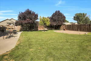 Fenced backyard with a patio area