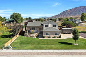 Tri-level home featuring brick siding, roof with shingles, a mountain view, and a residential view