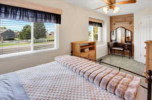 Carpeted bedroom with baseboards and ceiling fan
