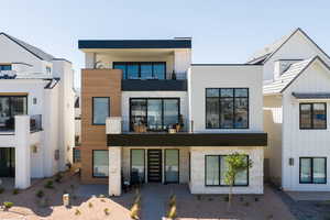 View of front facade featuring a balcony and stucco siding