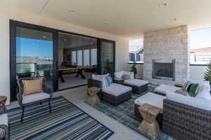View of patio with an outdoor living space with a fireplace