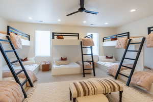 Carpeted bedroom featuring recessed lighting and a ceiling fan