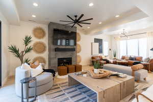Living room featuring light wood-style floors, a fireplace, recessed lighting, and ceiling fan