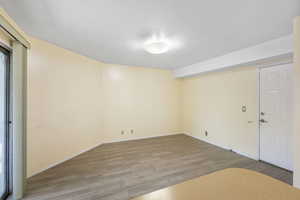 Spare room featuring light wood finished floors and a textured ceiling
